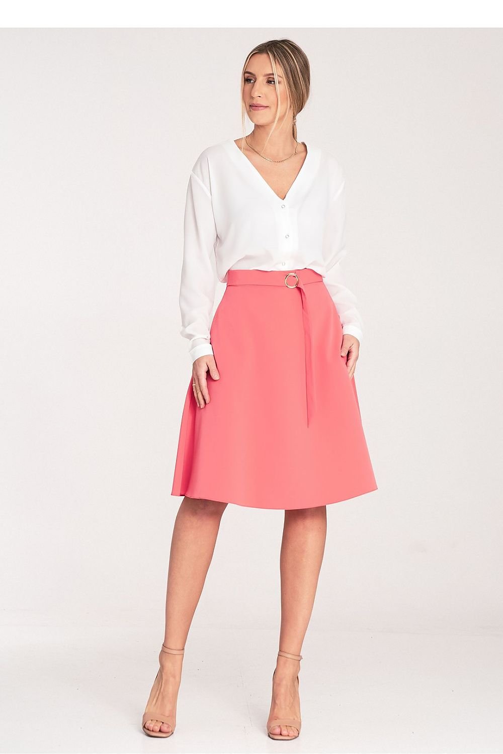 A flared, knee-length skirt with a loose fit, side seam pockets, a decorative buckle belt at the front, and a concealed back zip.

