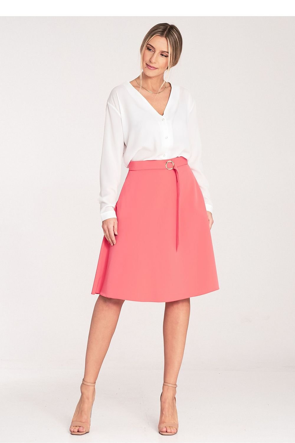 A flared, knee-length skirt with a loose fit, side seam pockets, a decorative buckle belt at the front, and a concealed back zip.

