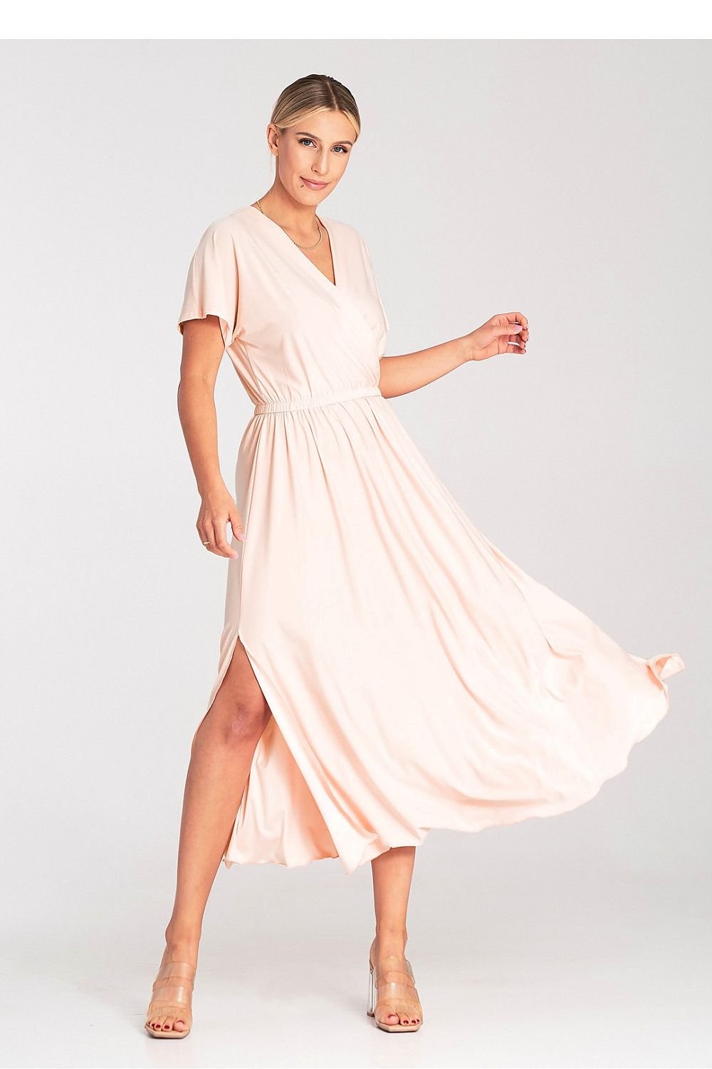 A stylish dress featuring an overlapping neckline, short draped sleeves, an elastic waistband, and asymmetrical side slits for added elegance.






