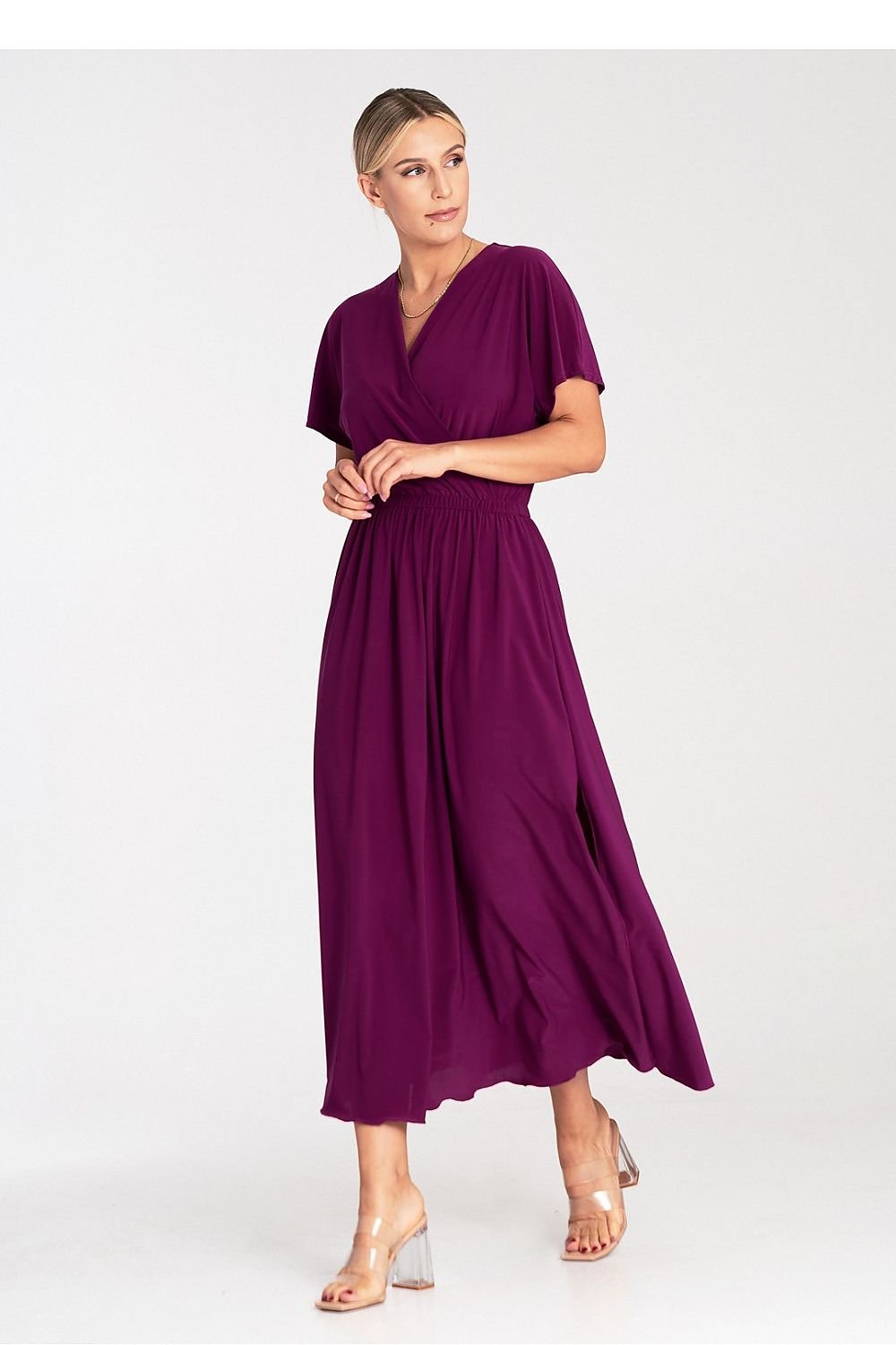 A stylish dress featuring an overlapping neckline, short draped sleeves, an elastic waistband, and asymmetrical side slits for added elegance.






