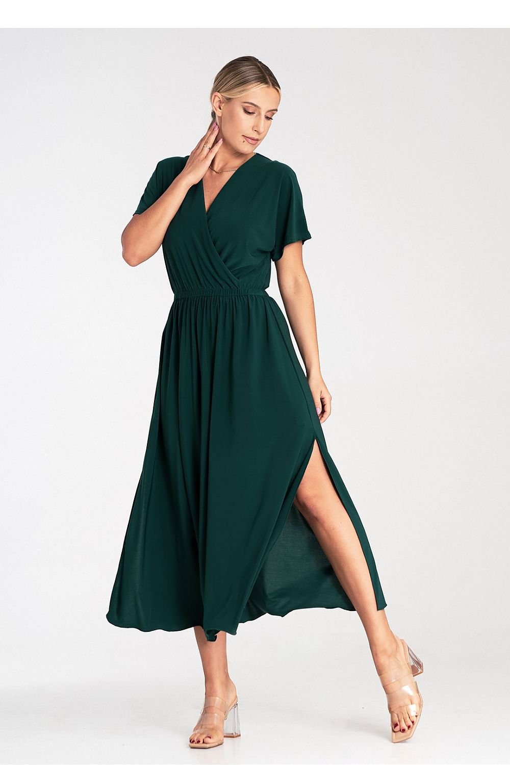 A stylish dress featuring an overlapping neckline, short draped sleeves, an elastic waistband, and asymmetrical side slits for added elegance.






