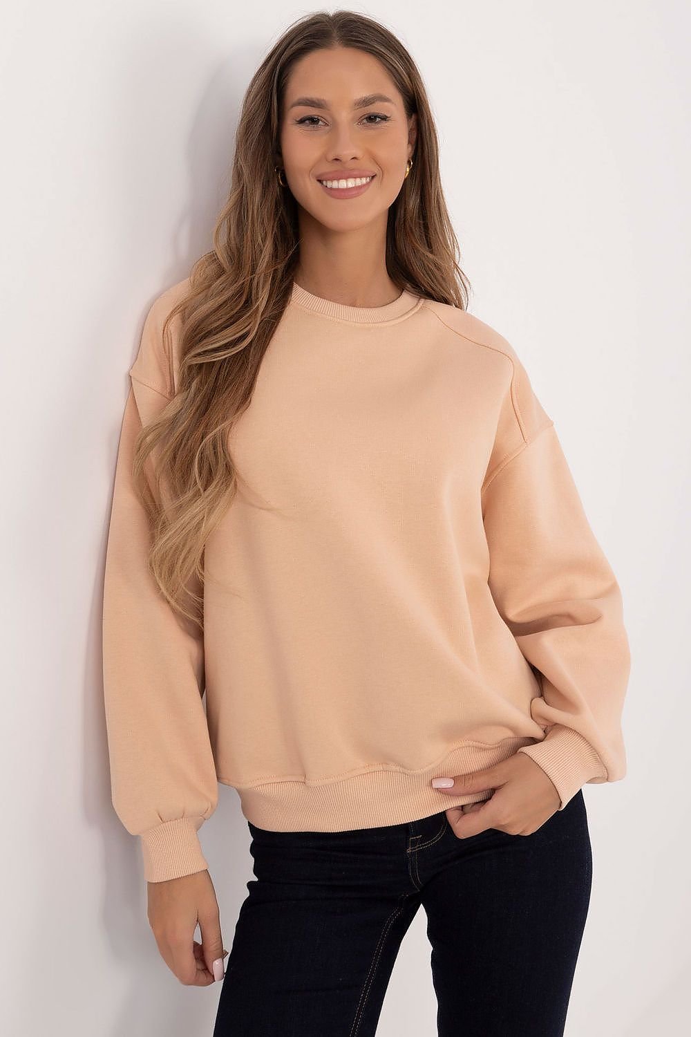 A women's casual beige sweatshirt with long sleeves, a round neckline, and inner insulation for colder days. Made from a durable cotton and polyester blend, it features a smooth, timeless design without a zipper, perfect for minimalist or layered styling. Comfortable and classic for everyday wear.






