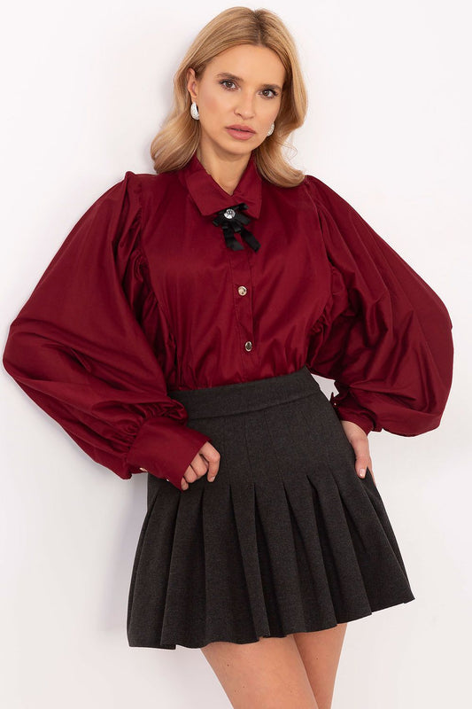 Women's formal shirt featuring long sleeves, a classic collar, and button-down closure. Made from polyester, viscose, and elastane for comfort and elegance, with decorative creases, buff sleeves, and a detachable brooch for versatile styling.