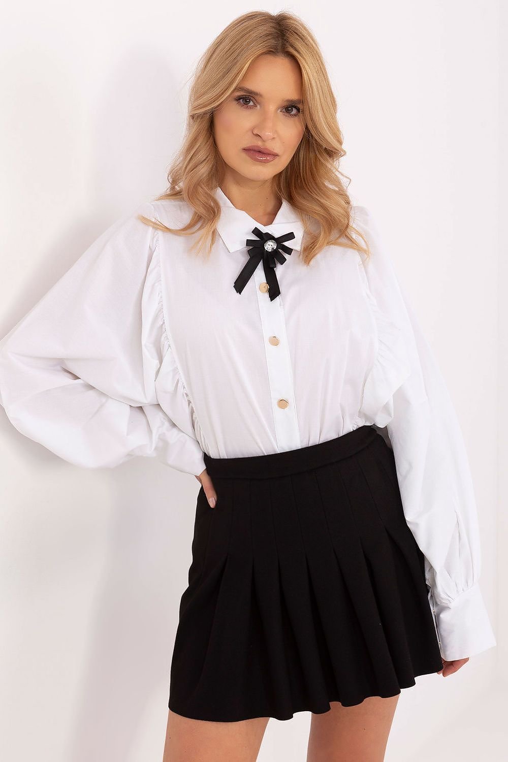 Women's formal shirt featuring long sleeves, a classic collar, and button-down closure. Made from polyester, viscose, and elastane for comfort and elegance, with decorative creases, buff sleeves, and a detachable brooch for versatile styling.