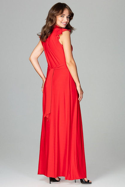 An elegant maxi dress fitted at the waist with slight flare at the bottom, featuring decorative frills on the shoulders and neckline, tied at the back, and buttoned at the top for a refined, feminine look.






