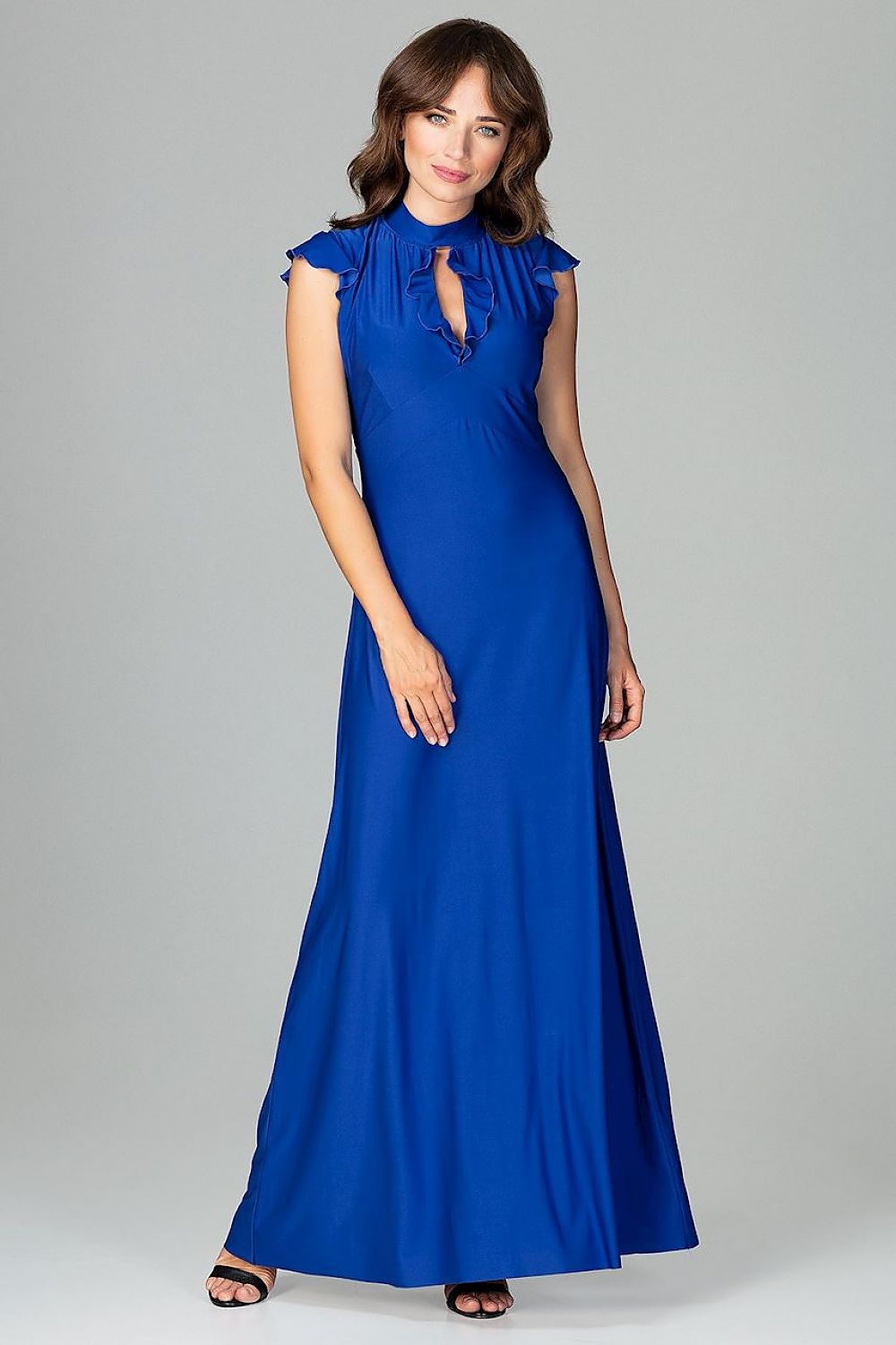 An elegant maxi dress fitted at the waist with slight flare at the bottom, featuring decorative frills on the shoulders and neckline, tied at the back, and buttoned at the top for a refined, feminine look.






