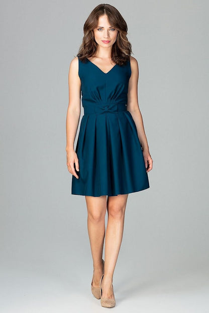 A sleeveless blue cocktail dress featuring a small bow at the waist, a delicate neckline, ruffles at the bottom, and a zipper, with a beautifully exposed back for a feminine and expressive look.






