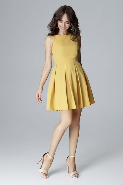 A sleeveless dress with a fitted top, low feminine neckline, and a waist-cut design with a flared bottom arranged in wide folds, perfectly emphasizing and slimming the waist.






