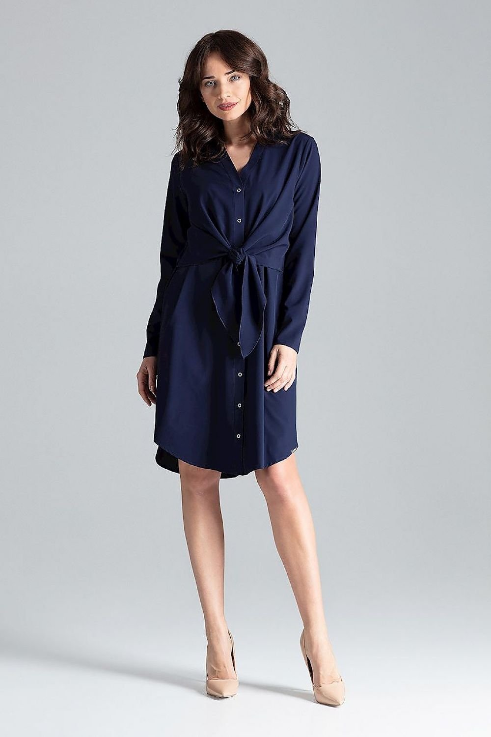 vShirt dress with a tie at the waist fastened by decorative springs, featuring a cheese neckline and long straight sleeves. Designed to provide a flattering silhouette for women who wish to conceal figure imperfections.






