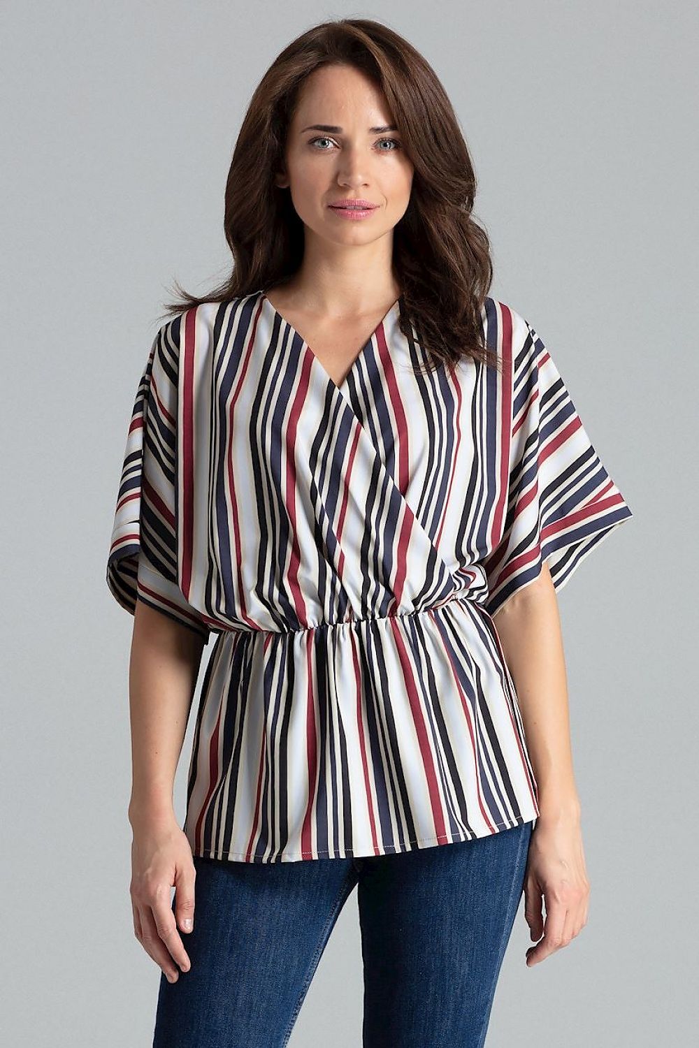 A loose-fitting floral blouse with short kimono sleeves featuring cuffed ends, an envelope neckline, and an elastic waist. The blouse falls gracefully over the hips.