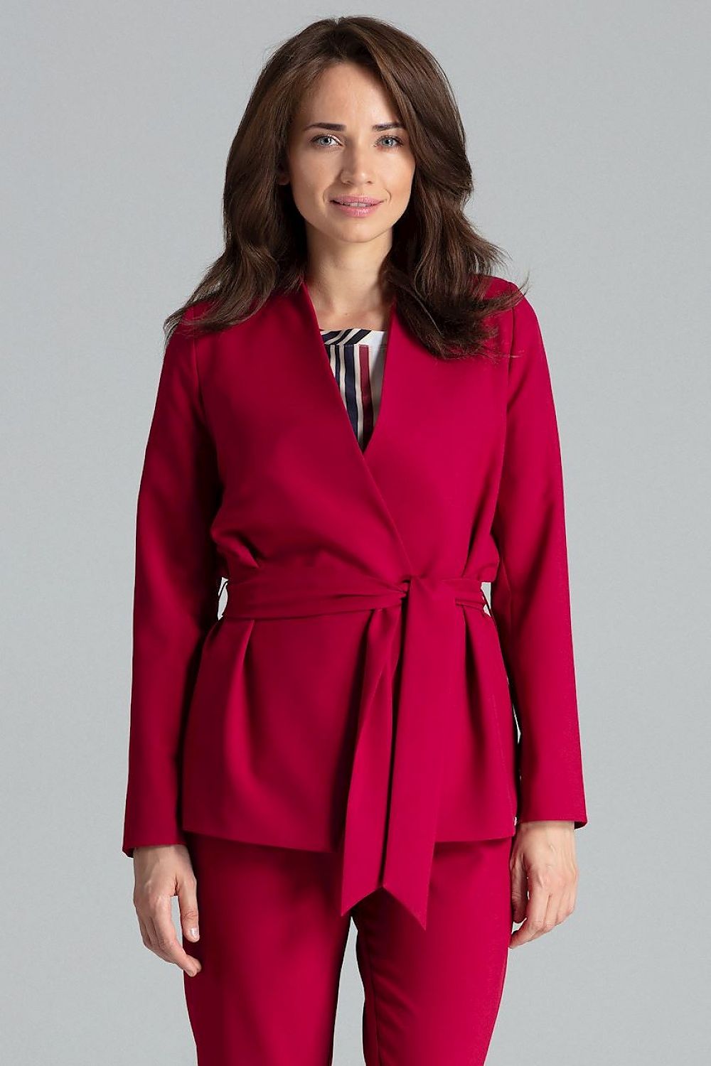 A simple jacket featuring an asymmetrical front and no button closure, with a sash tie at the waist for a refined fit. Lined in the same color as the jacket, this sleek design has no pockets, offering a minimalist and elegant look perfect for versatile styling.