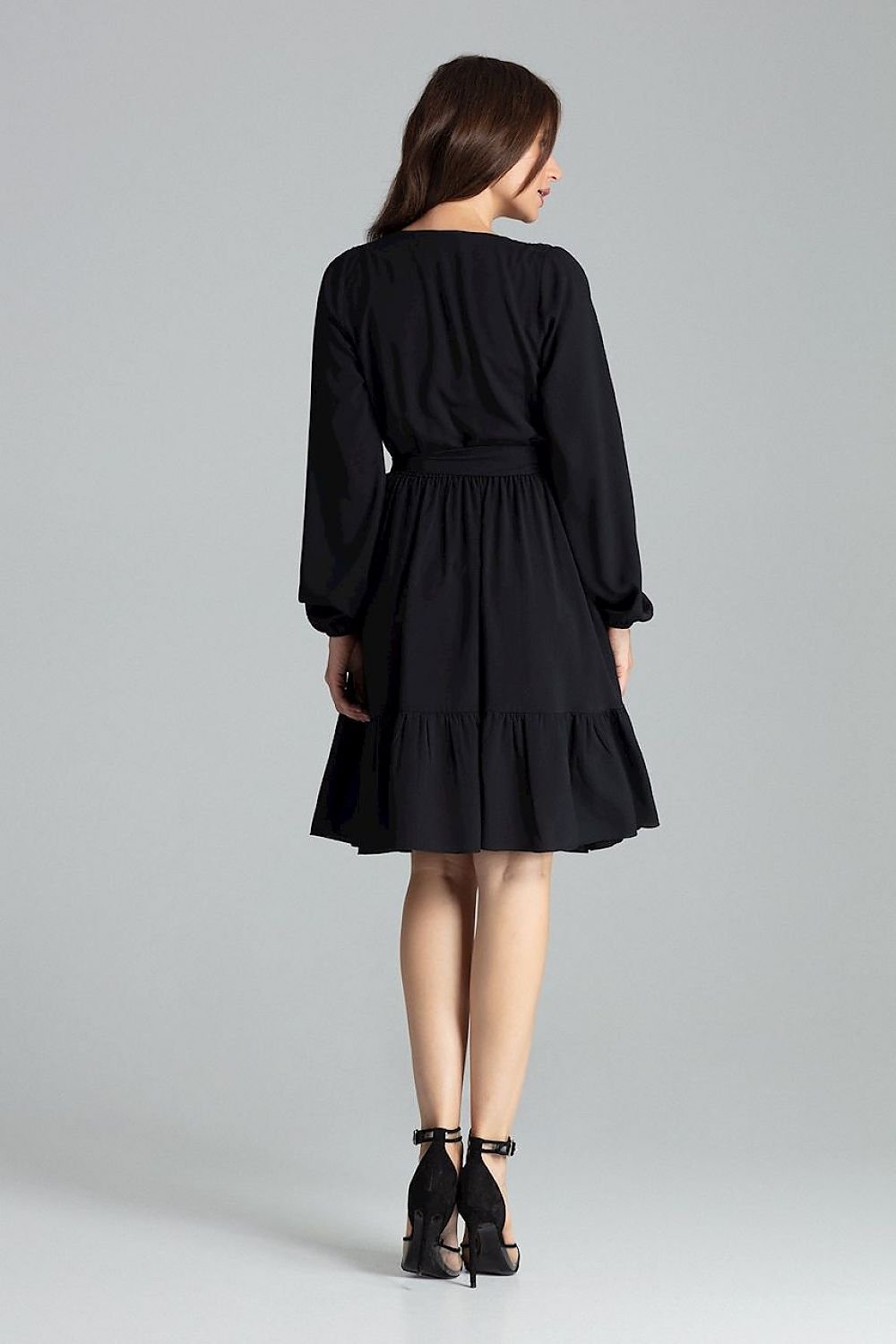 A  midi dress featuring long sleeves with creased elastic cuffs, an envelope neckline, a frilled bottom skirt, an elastic waistband, and an additional sash to tie for a feminine silhouette.






