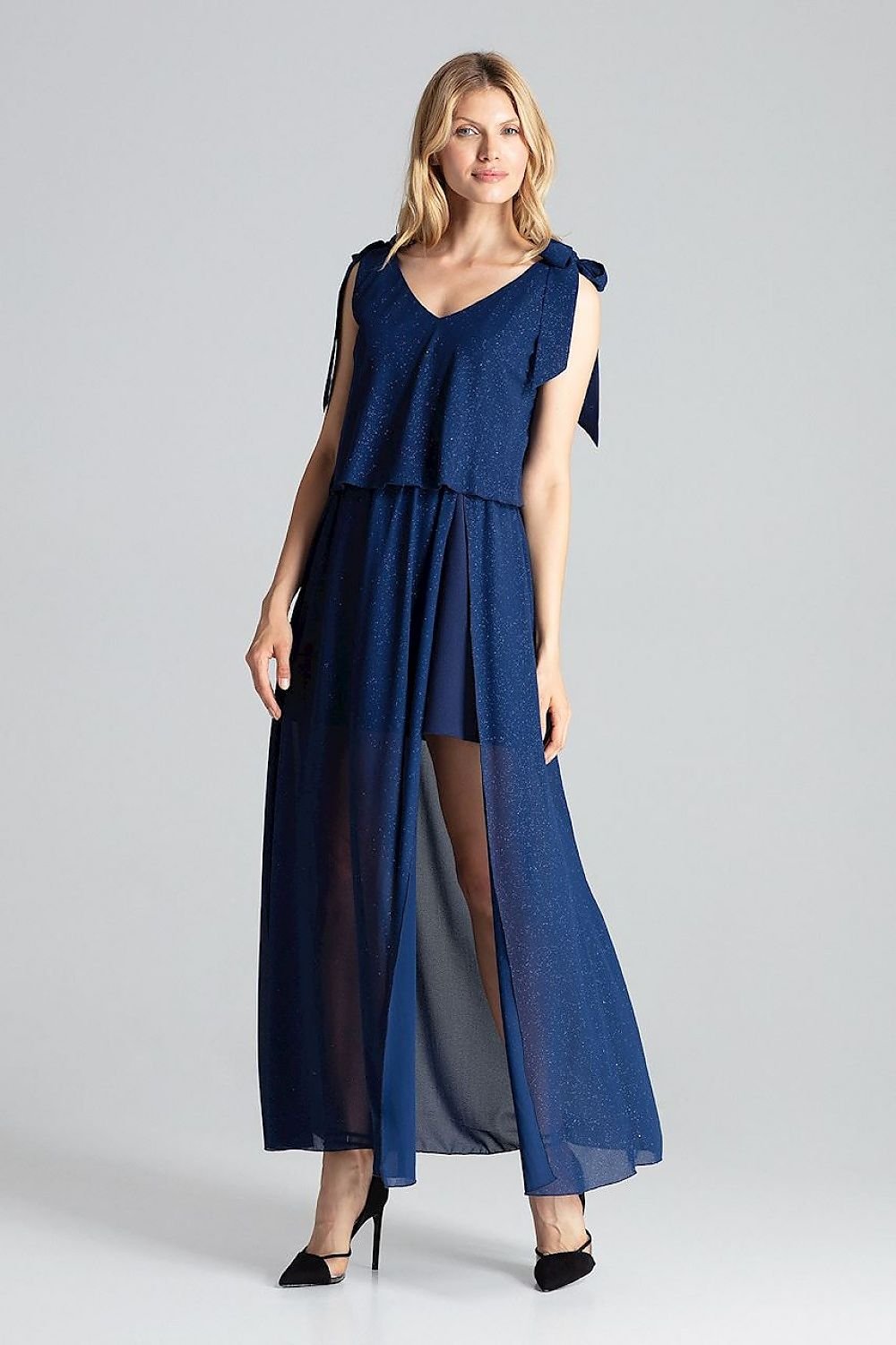 A sensual navy blue long sleeveless dress with a large deep neckline, tied at the shoulders, featuring airy fabric at the top, an elastic waistband, and a side slit from the waist to a slightly flared bottom before the knee.






