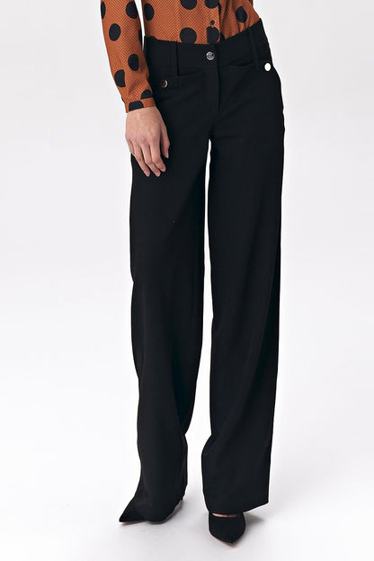 Black women’s trousers in a fashionable palazzo cut, featuring decorative press-studs that add a modern touch to classic office styling. Made from a comfortable viscose-blend fabric, these trousers offer both elegance and high wearing comfort, perfect for soft-office style.

