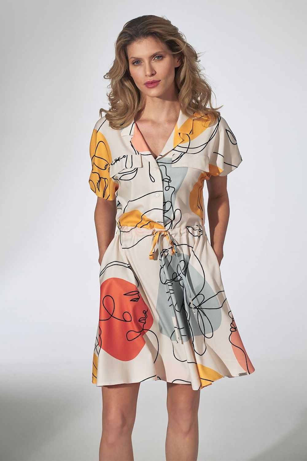 Stylish kimono mini dress featuring a floral pattern, decorative patches on the bust line, and a 3-button fastening. The drawstring waist, elastic band cuffs, and flared bottom add a flattering shape, while side-seam pockets add practicality. Unlined for a light, comfortable feel.