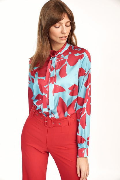 Chic blouse featuring a bold front pattern, perfect for adding color and flair to classic styles like jackets and trousers.