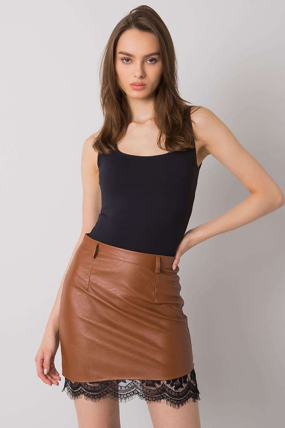 A stylish brown mini skirt made from ecological leather, featuring a decorative black lace hem and a concealed zip closure, worn with a black sleeveless top.
