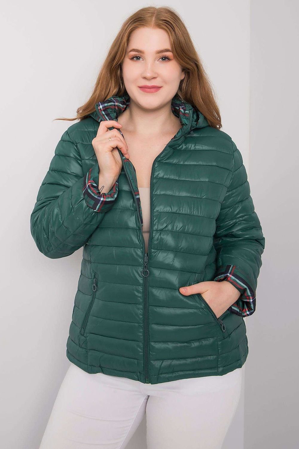 A dark green reversible plus-size jacket featuring a detachable zipped hood. Fully lined with warming for added comfort, this jacket offers versatility and warmth for various weather conditions.