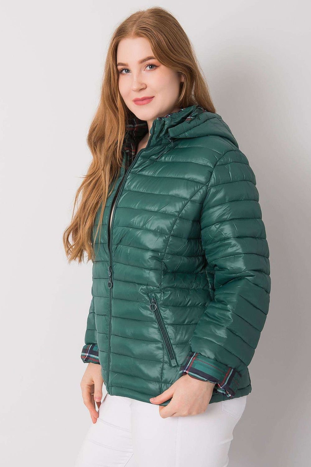 A dark green reversible plus-size jacket featuring a detachable zipped hood. Fully lined with warming for added comfort, this jacket offers versatility and warmth for various weather conditions.