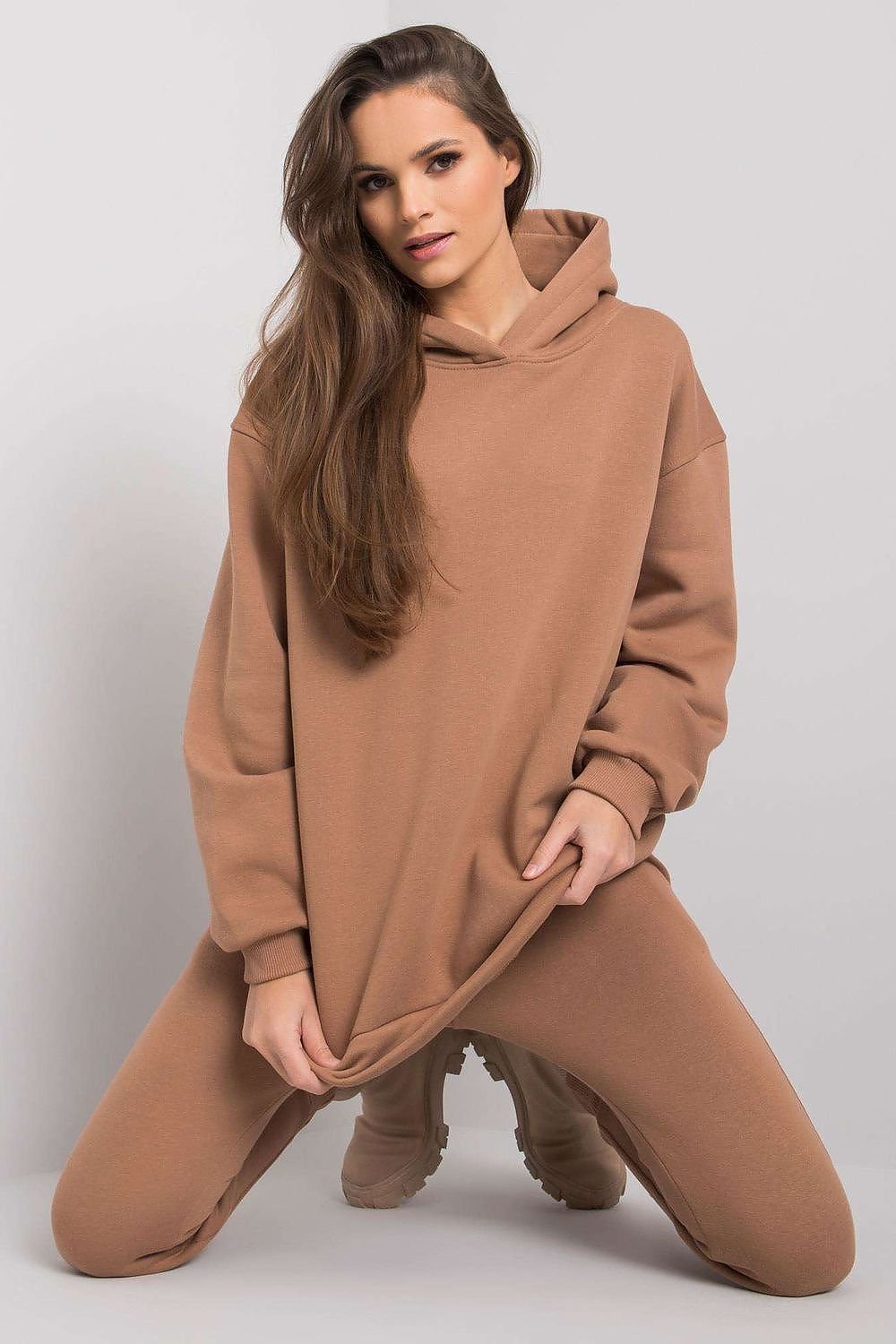 A comfortable set featuring a hooded sweatshirt with a kangaroo pocket, paired with straight-cut sweatpants, perfect for relaxed and casual styling.