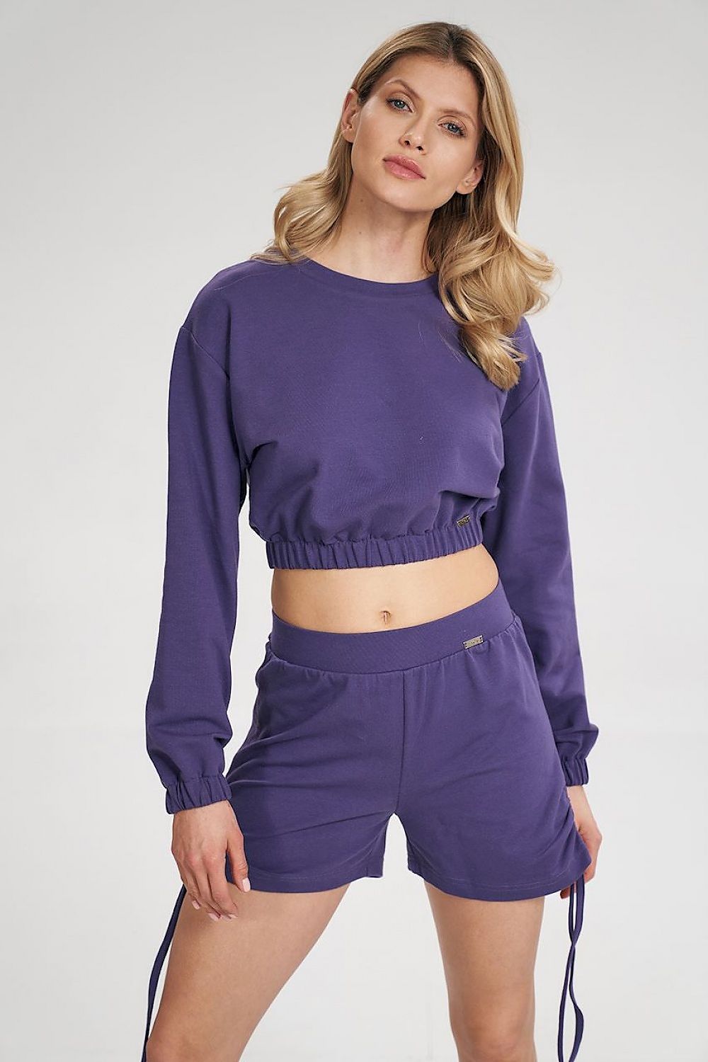 A trendy long sleeve crop sweatshirt featuring a half-round neckline, with sleeves and bottom hem finished with a wide elastic band for a comfortable and modern fit. Perfect for casual, stylish looks.






