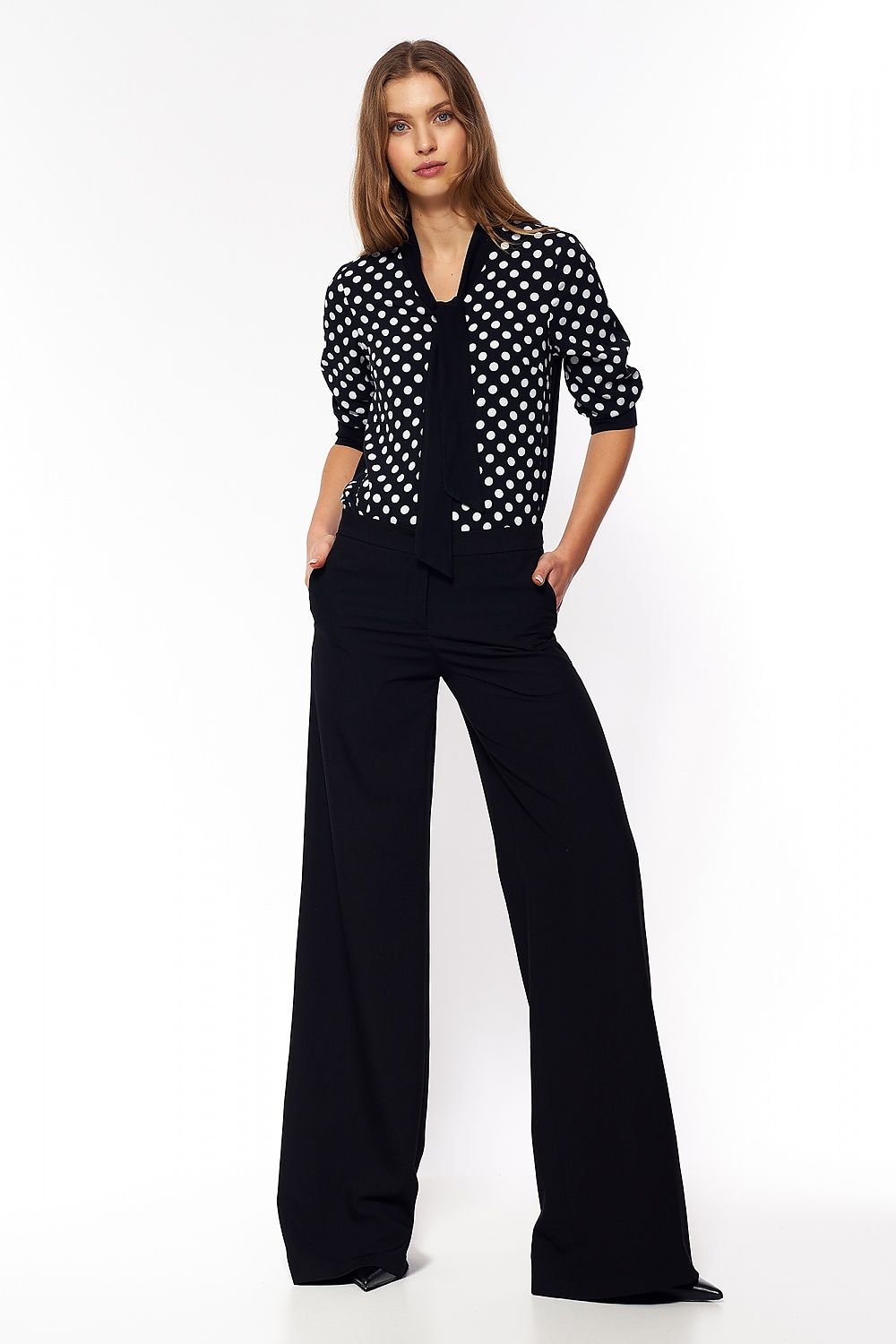 Black palazzo pants with a touch of elastane for added comfort. Perfect for soft-office style, offering a fresh, non-traditional color that breaks classic office styling while providing a comfortable and stylish fit.

