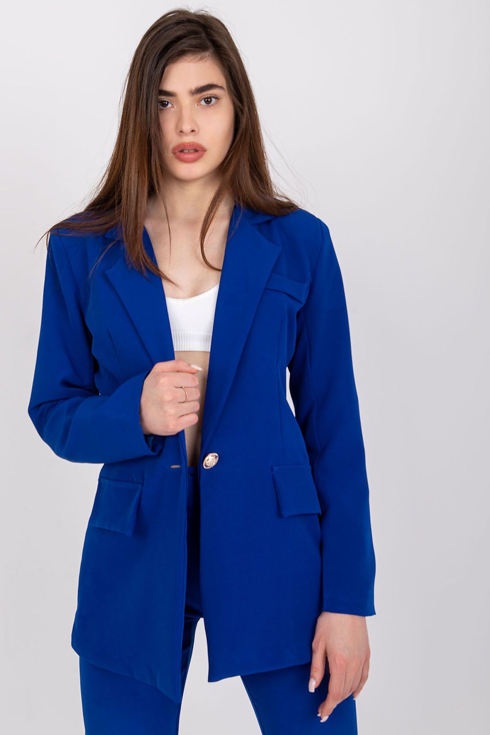 A sophisticated long-sleeved ladies' jacket with a button fastening, featuring a lined interior, imitation pockets, and shoulder cushions. A versatile choice, ideal for various occasions, blending timeless style and comfort.






