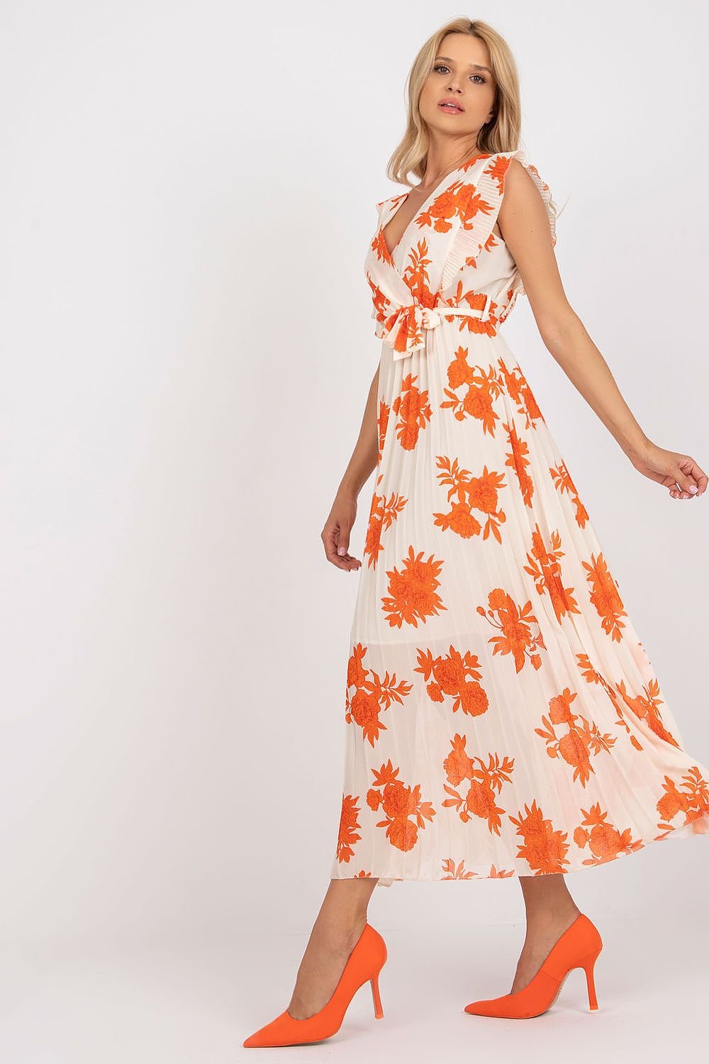 Stylish long summer dress featuring short frilled sleeves, a waist tie, and a pleated bottom for added texture and movement. Ideal for warm weather, this dress combines comfort and elegance for any summer occasion.