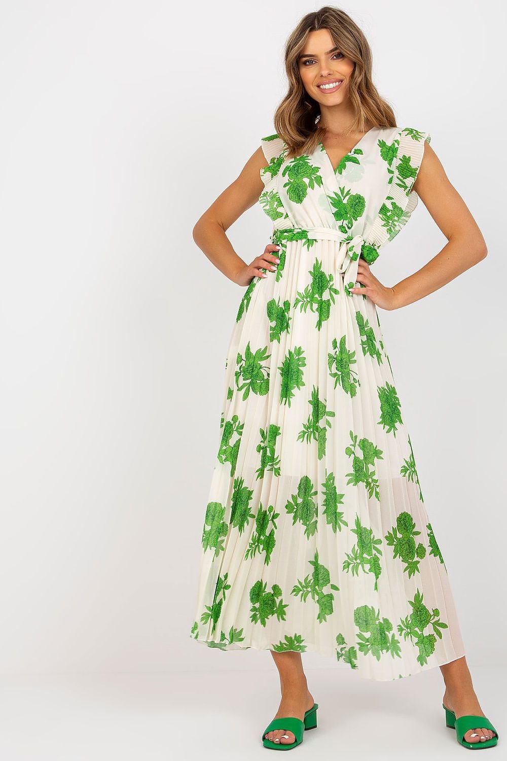 Stylish long summer dress featuring short frilled sleeves, a waist tie, and a pleated bottom for added texture and movement. Ideal for warm weather, this dress combines comfort and elegance for any summer occasion.