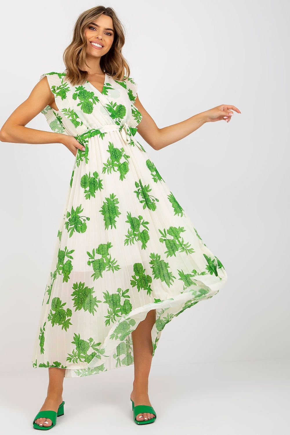 Stylish long summer dress featuring short frilled sleeves, a waist tie, and a pleated bottom for added texture and movement. Ideal for warm weather, this dress combines comfort and elegance for any summer occasion.