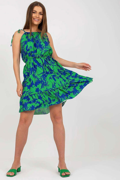 Light and breezy summer dress featuring floral print, tied straps, a waist tie, and a ruffled hem for a feminine touch. Perfect for warm weather and casual outings.