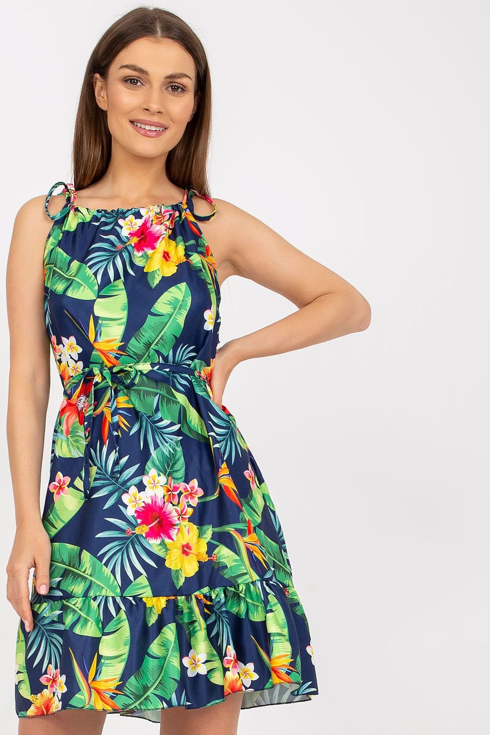 Light and breezy summer dress featuring floral print, tied straps, a waist tie, and a ruffled hem for a feminine touch. Perfect for warm weather and casual outings.