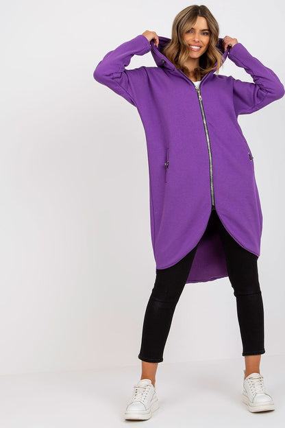 An elongated purple sweatshirt with a zip-up design, long sleeves, an attached hood, and slip-in side pockets. Ideal for casual comfort and style.






