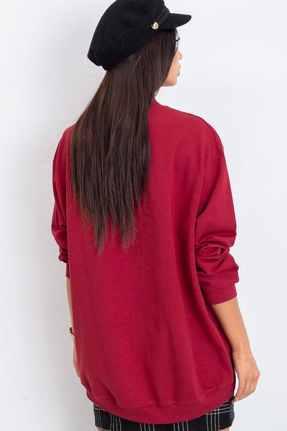 A women's red cotton sweatshirt with long sleeves and a stand-up collar, crafted from high-quality, breathable material for exceptional comfort. Ideal for pairing with tight pants or skirts for a stylish and versatile look.






