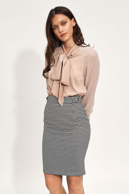 A black fitted pencil skirt with a high waist, designed to emphasize the waist and hips, perfect for both office styling and casual outings, depending on whether paired with a white shirt or a satin black top.






