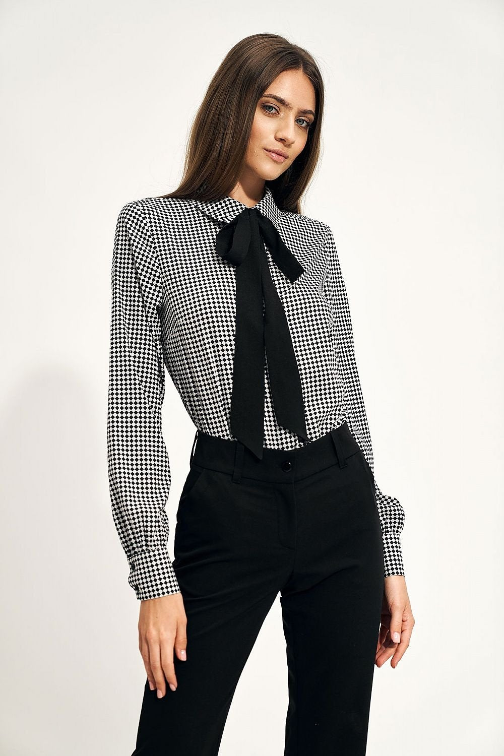 A gently waisted blouse with a stylish bow under the neck, perfect for work or meetings. Pairs effortlessly with classic pants or a skirt for a polished office look.