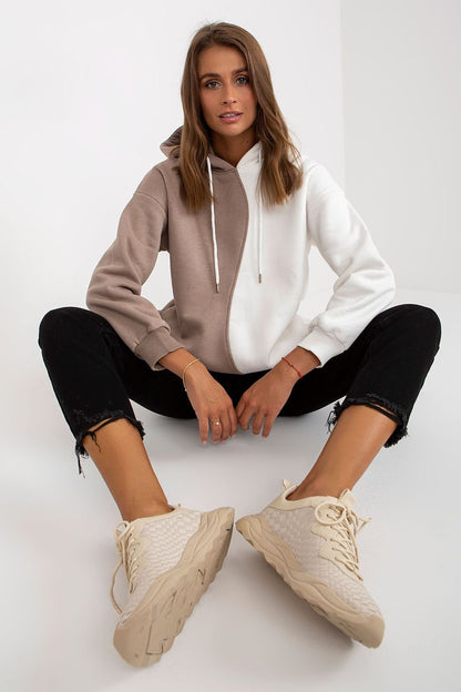  Stylish women's two-color sweatshirt with long sleeves, a cozy hood, and convenient side slip pockets for added comfort and practicality.