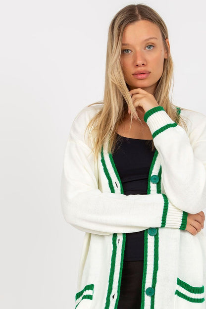 A stylish long-sleeved cardigan featuring a button closure, slip pockets on the sides, and a contrast trim, offering a chic and functional look.