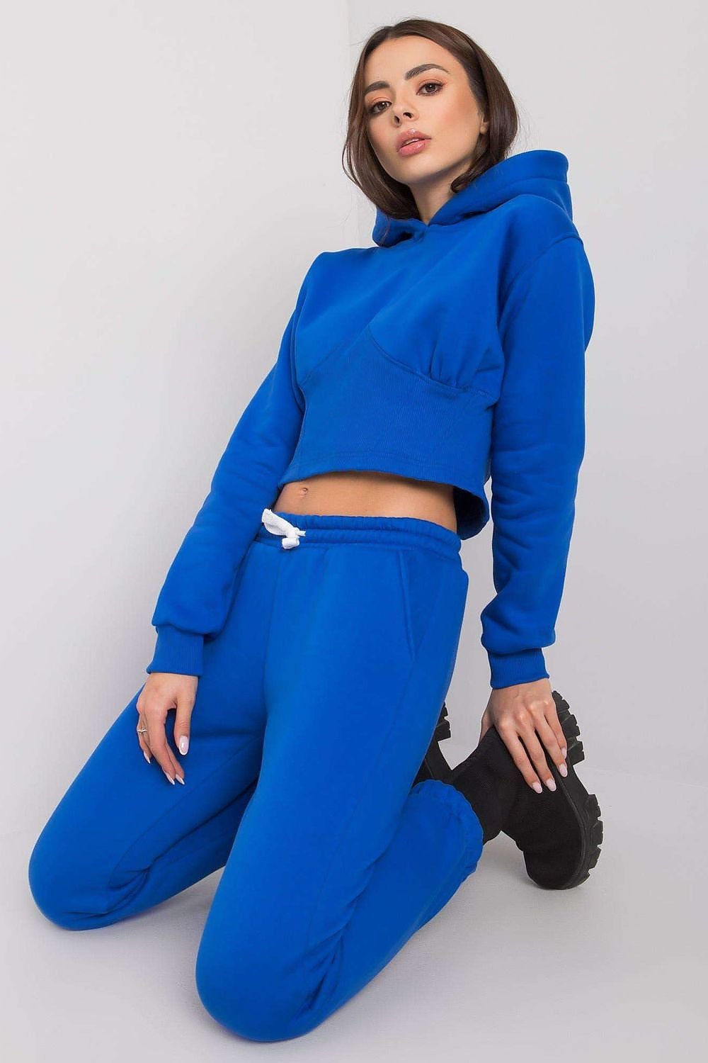 Comfortable and stylish women's sweatshirt set featuring a short hoodie with long sleeves and a hood, paired with long pants that have a waist tie and slip pockets. Ideal for casual wear or lounging, offering a perfect blend of fashion and comfort.