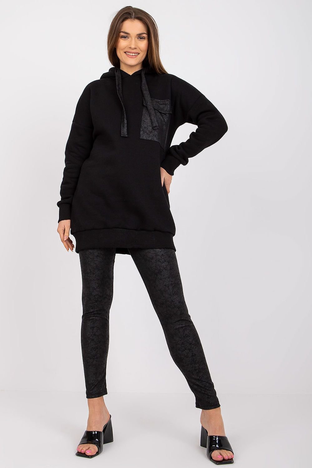 A sweatshirt set featuring a long-sleeve sweatshirt with a hood, paired with leggings that have a wide elastic waistband for comfort and style.






