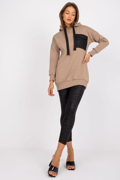 A sweatshirt set featuring a long-sleeve sweatshirt with a hood, paired with leggings that have a wide elastic waistband for comfort and style.






