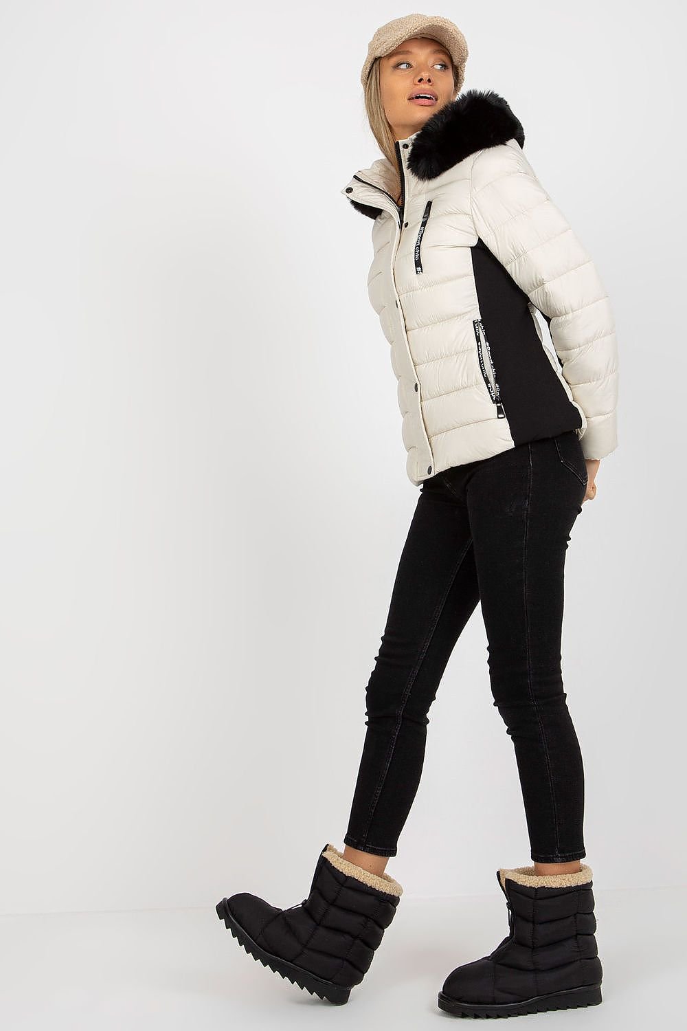 A stylish quilted down jacket with long sleeves, a zip and press-stud closure, and zippered pockets. Fully lined for warmth, it features a detachable hood with decorative fur, offering both functionality and elegance.