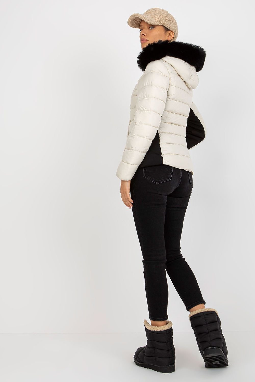 A stylish quilted down jacket with long sleeves, a zip and press-stud closure, and zippered pockets. Fully lined for warmth, it features a detachable hood with decorative fur, offering both functionality and elegance.