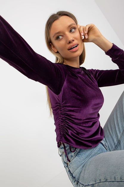 Stylish short velour blouse with long sleeves, round neckline, and adjustable side ties for a customizable fit.