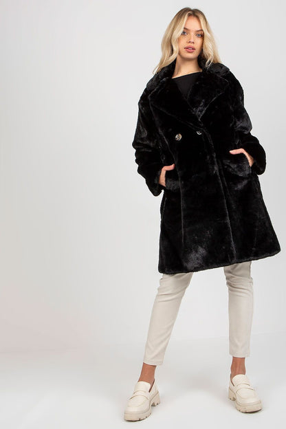 Soft polyester faux fur coat with long sleeves, button closure, side slip pockets, and fully lined for comfort.






