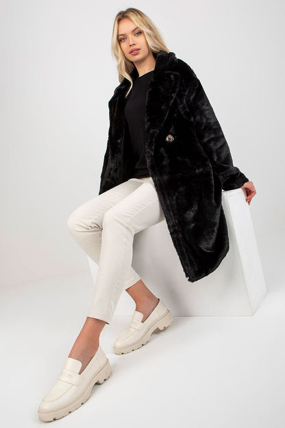 Soft polyester faux fur coat with long sleeves, button closure, side slip pockets, and fully lined for comfort.






