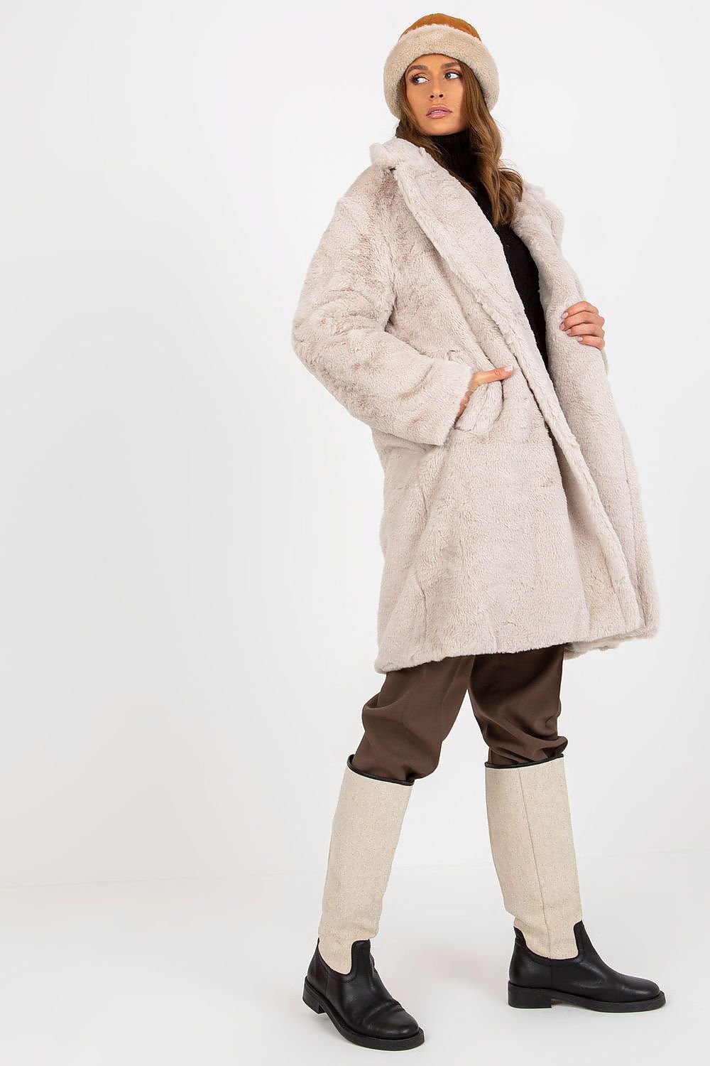 Soft polyester faux fur coat with long sleeves, button closure, side slip pockets, and fully lined for comfort.






