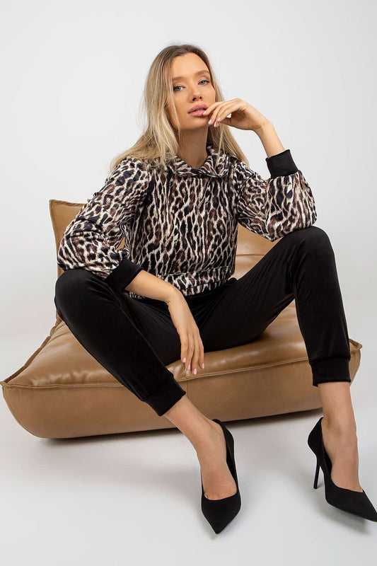 A comfortable velour set featuring a hooded sweatshirt with animal print and a kangaroo pocket, paired with long pants with slip pockets, offering a stylish and casual look.