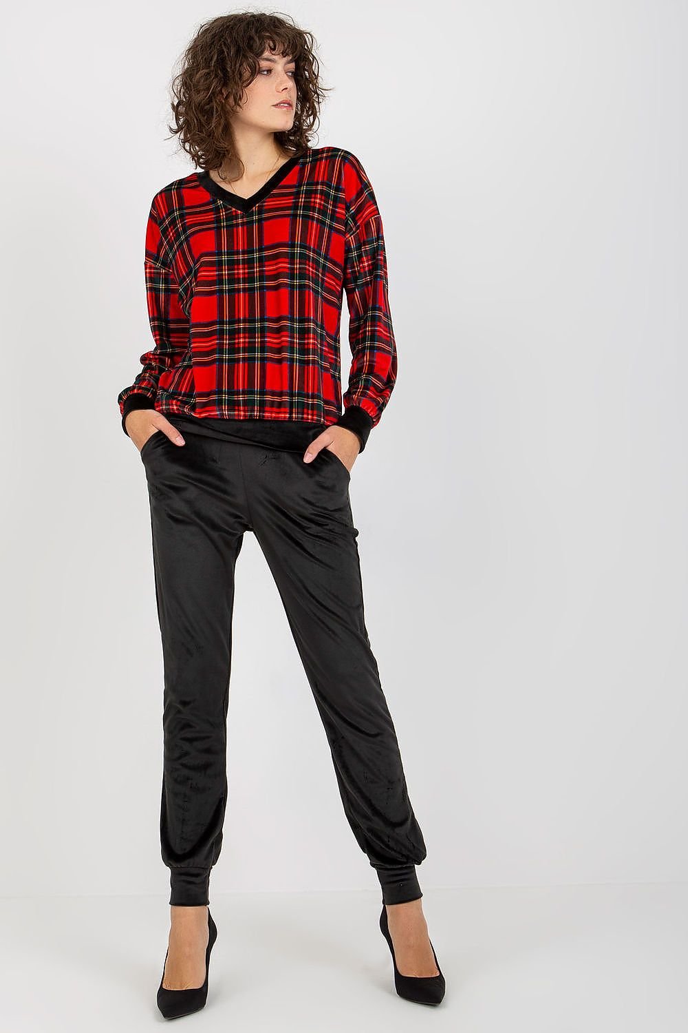 A chic velour set featuring a long-sleeved blouse with a checkered pattern, paired with black long pants with slip pockets, offering comfort and a stylish look.