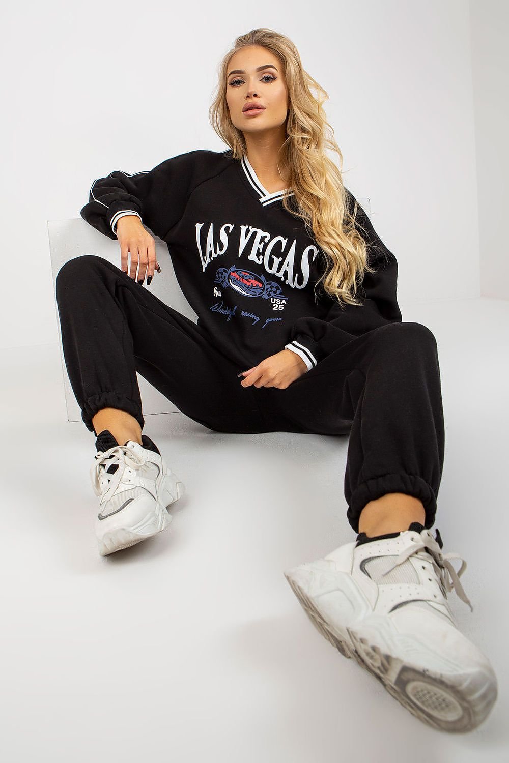 A casual set featuring a long-sleeve sweatshirt with a heart-shaped neckline, paired with long pants with a waist tie and slip pockets, offering comfort and style with a Las Vegas-inspired design.